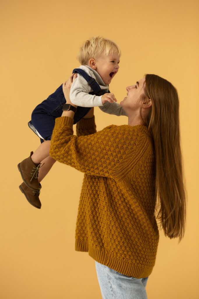 medium-shot-smiley-mother-holding-kid